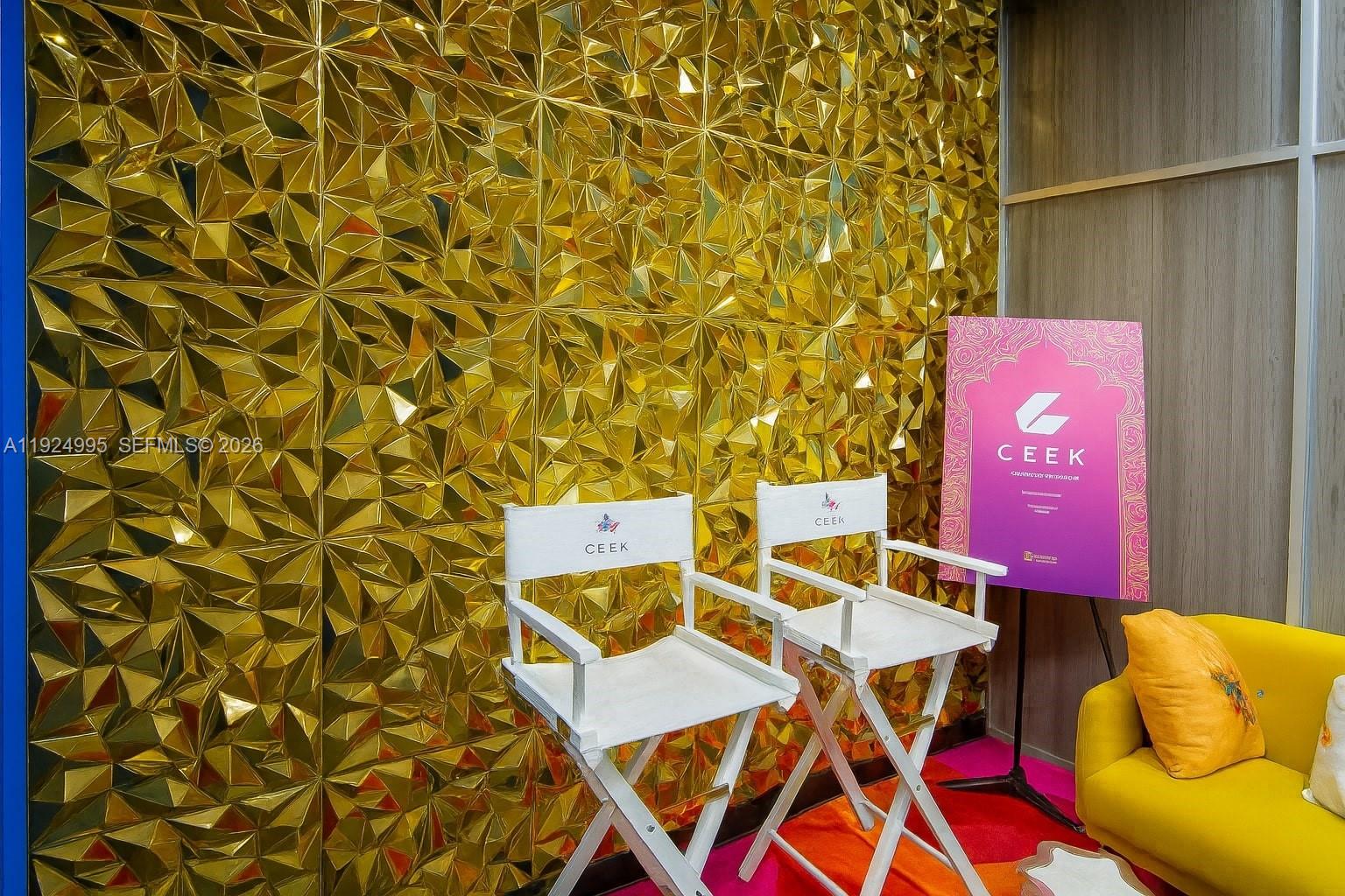 Two white director chairs sit in front of a geometric gold wall — 1500 NW 89th Ct # 209, Doral FL 33172, DORAL, FL