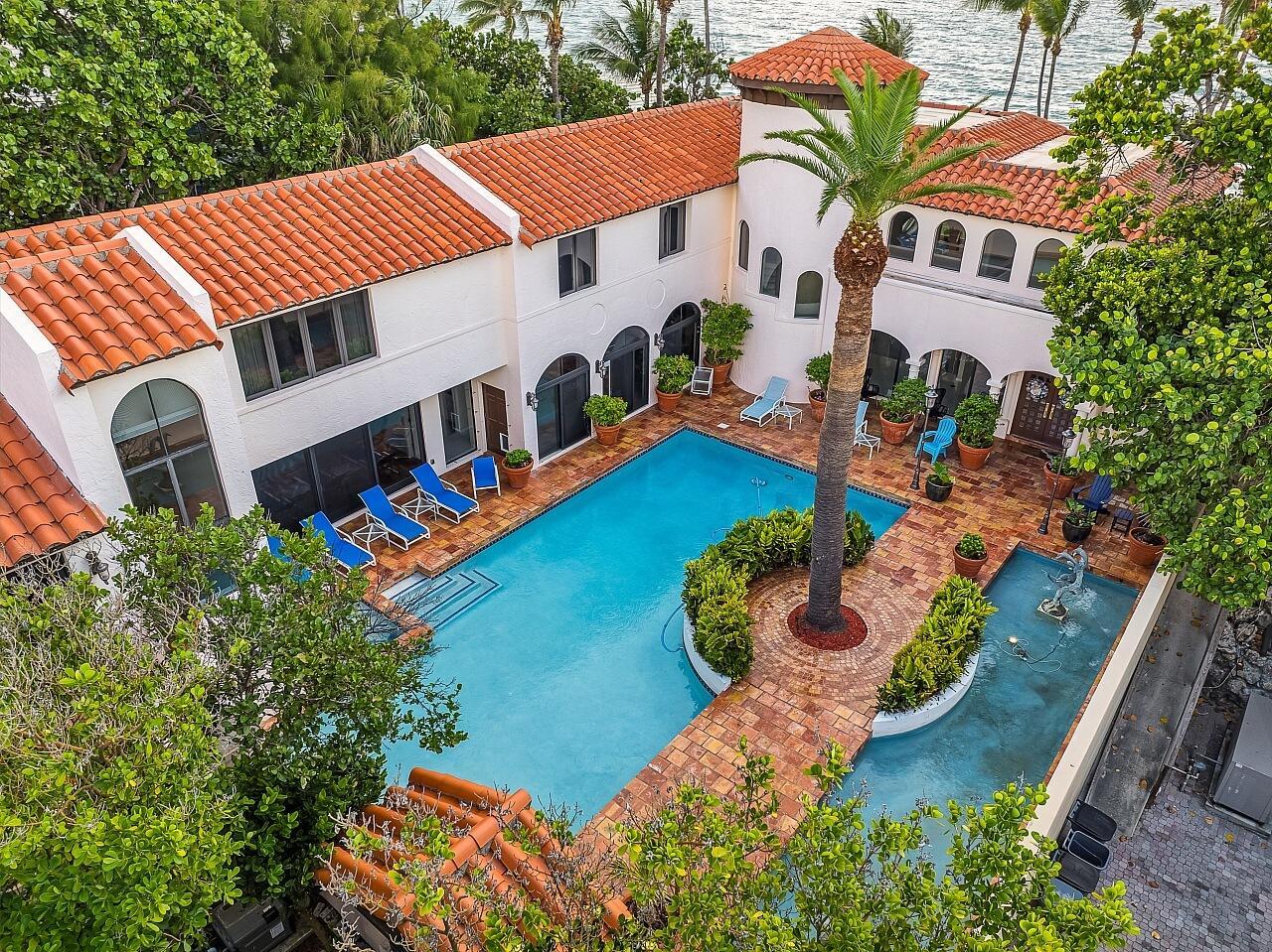 An aerial view of a white villa with a red tile roof and swimming pool — 1 Ocean Lane, Manalapan FL 33462, MANALAPAN, FL