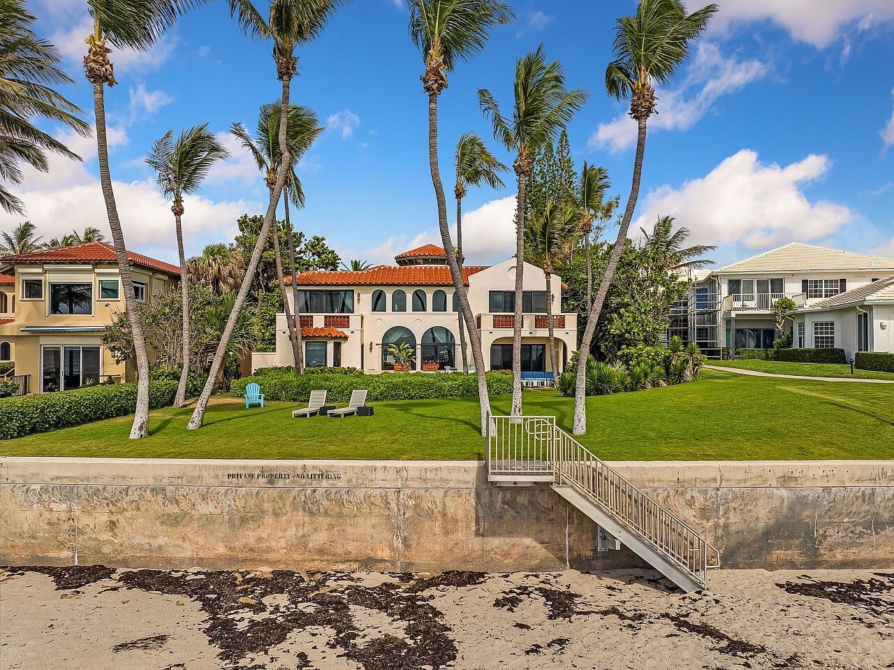 A beachfront house with a lawn, palm trees, and stairs leading down to the sand — 1 Ocean Lane, Manalapan FL 33462, MANALAPAN, FL