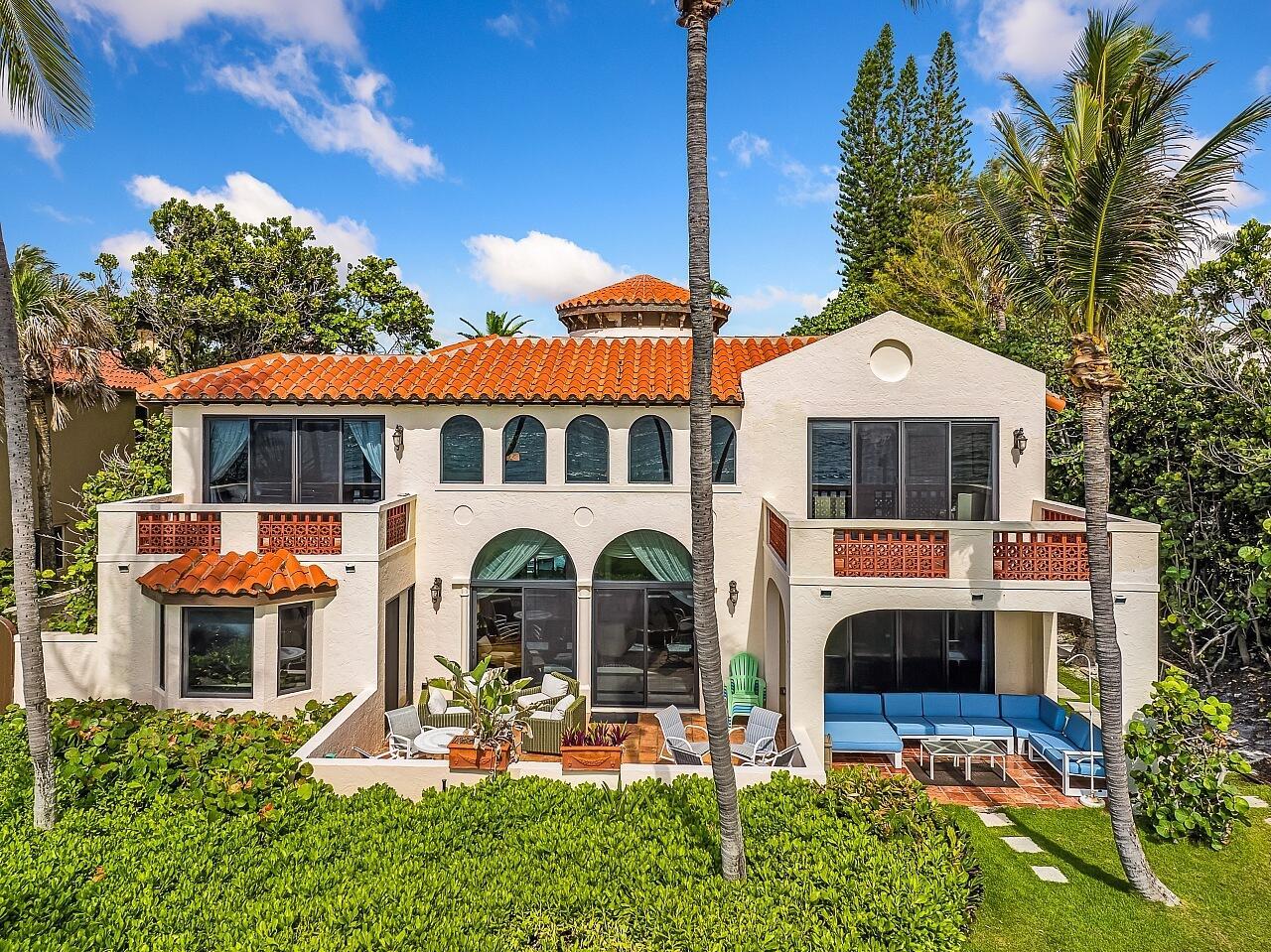 A two-story stucco house with a red tile roof, arched windows, and a patio area — 1 Ocean Lane, Manalapan FL 33462, MANALAPAN, FL