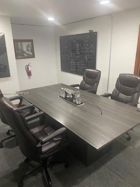 An office space features several gray desks, black chairs, and artwork on a gray wall — 5582 NE 4th Ct # 6A, Miami FL 33137, MIAMI, FL