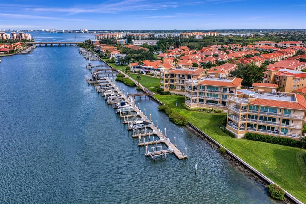 An aerial view of a waterfront condominium complex with a private boat dock and marina — 43 BAYVIEW COURT S UNIT A, ST PETERSBURG, FL