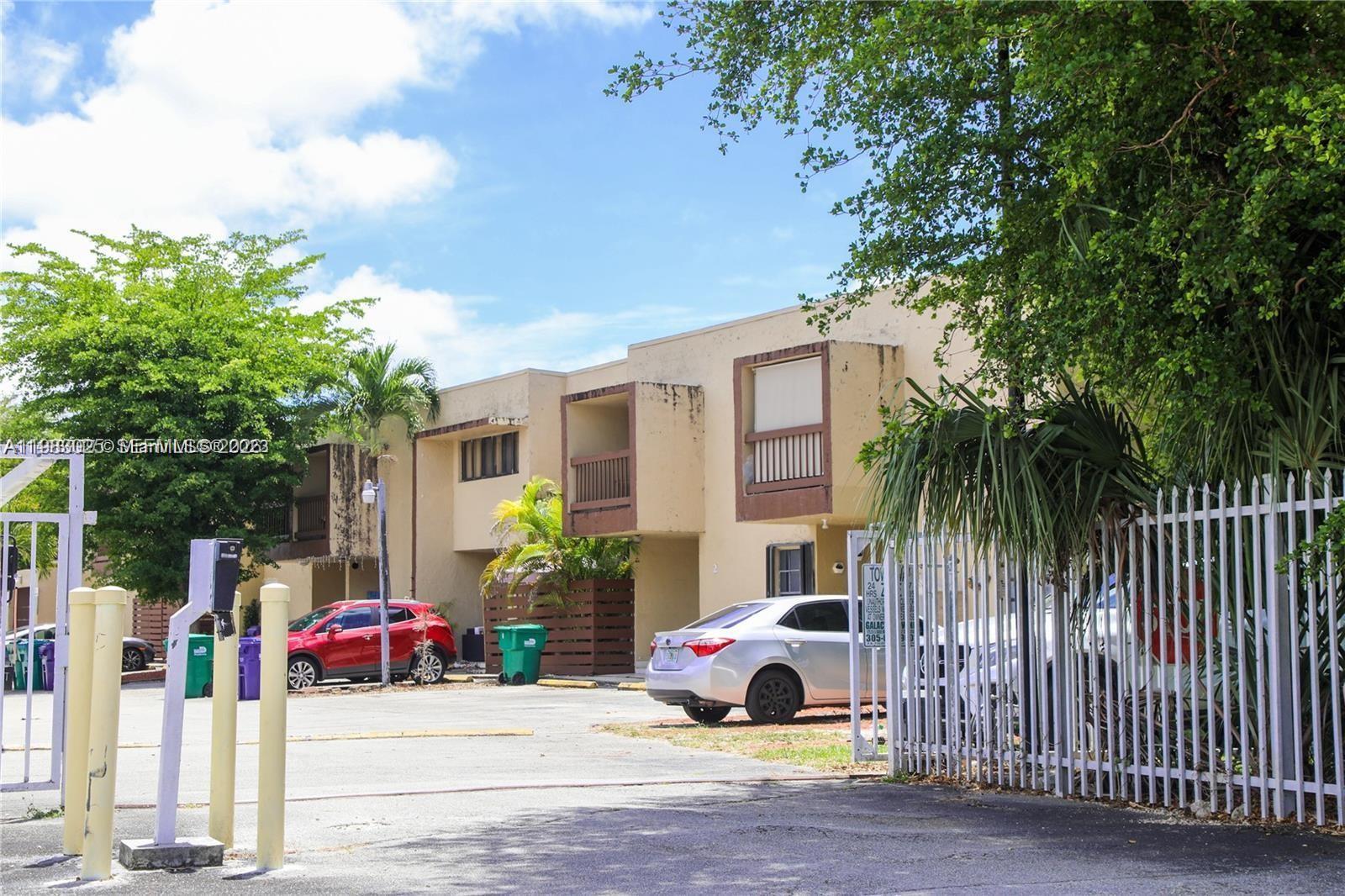 A two-story apartment building with a parking lot and gated entrance — 6335 SW 138th Ct # 1, Miami FL 33183, MIAMI, FL