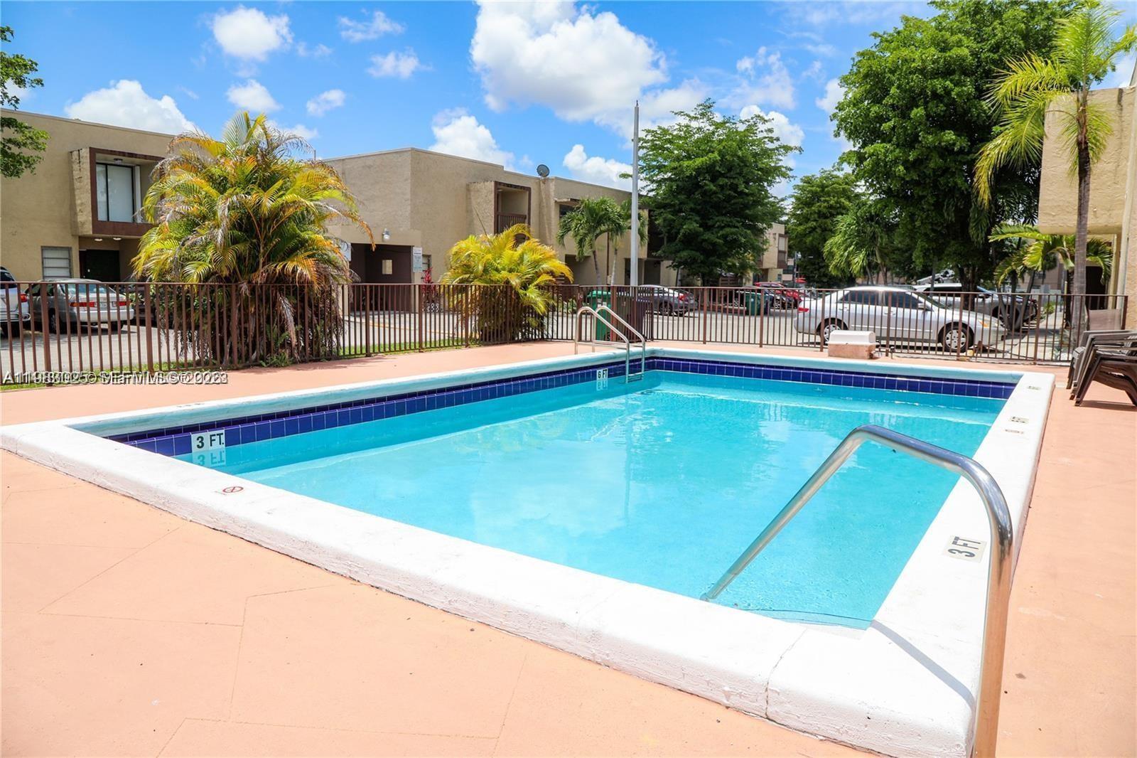 A rectangular swimming pool with a shallow end is surrounded by a tan deck — 6335 SW 138th Ct # 1, Miami FL 33183, MIAMI, FL