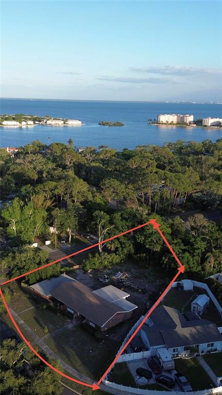 An aerial view shows a residential lot with a house and surrounding trees near water — 400 LAKE MAGGIORE BOULEVARD S, ST PETERSBURG, FL