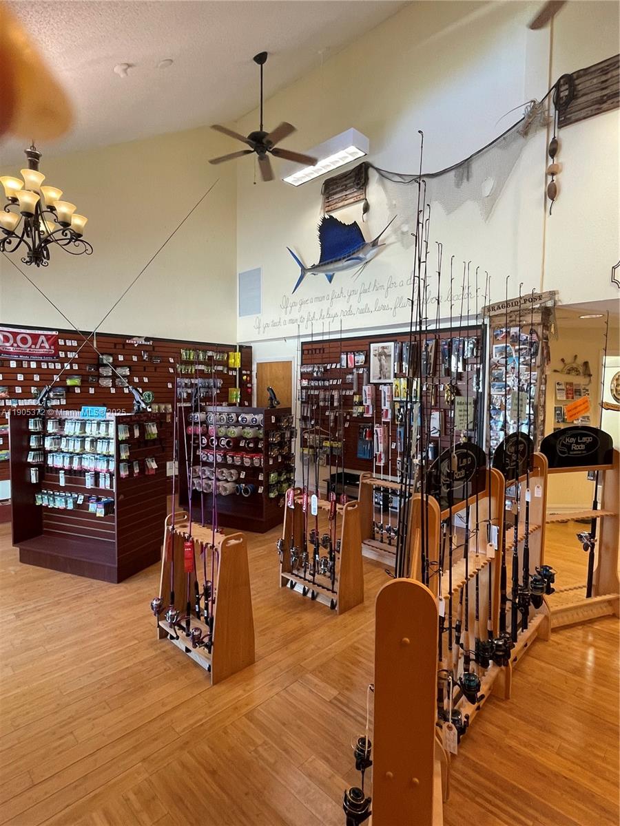 This retail store features wooden flooring, fishing rod displays, and a mounted sailfish on the wall — 102970 Overseas Hwy, Key Largo FL 33037, KEY LARGO, FL