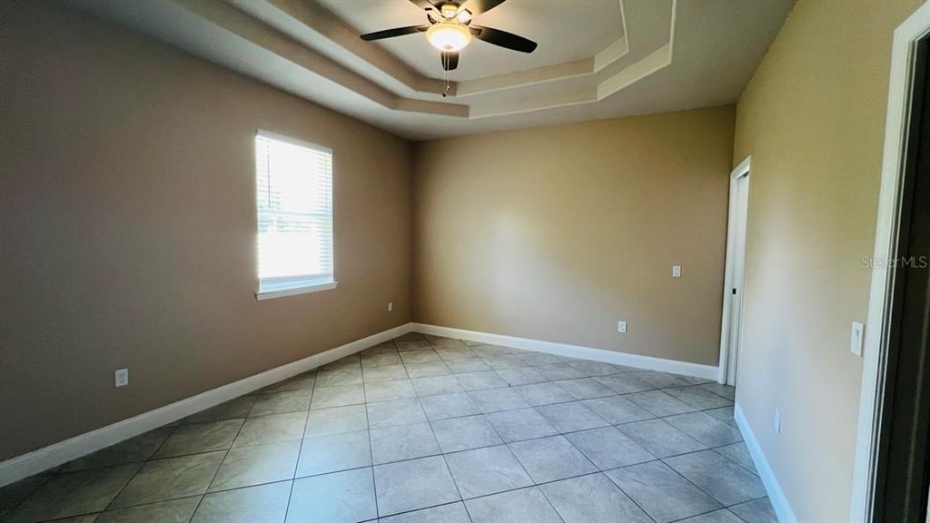 A bathroom features a dark wood vanity, a white toilet, and a glass-enclosed walk-in shower — 57 COLUMBIA LANE UNIT B, PALM COAST, FL