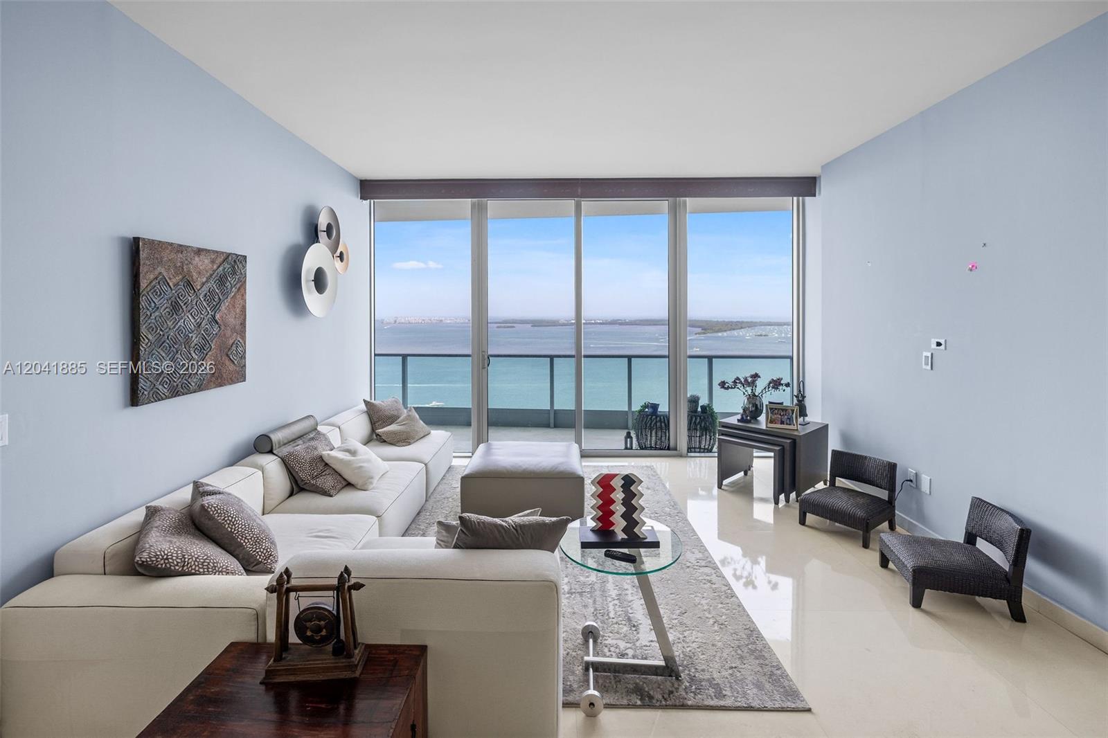 A living room features a white sectional sofa, glass coffee table, and floor-to-ceiling windows — 1331 Brickell Bay Dr # 2909, Miami FL 33131, MIAMI, FL