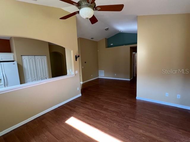 An empty room with wood-look flooring, tan walls, and a ceiling fan — 77 VERANDA WAY, PALM COAST, FL