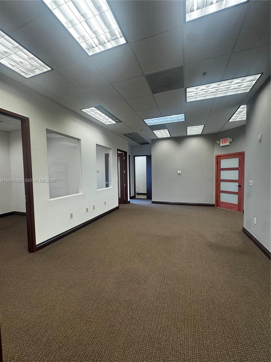 This office space features carpeted flooring, drop ceilings with recessed lighting, and several interior doors — 1655 N Commerce Pkwy # 301, Weston FL 33326, WESTON, FL