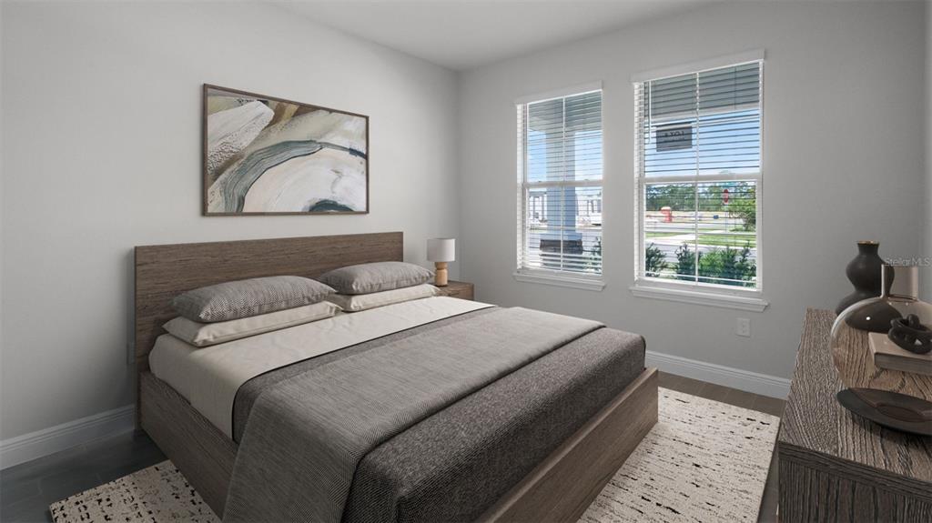 A bedroom features a wooden bed frame, two windows, and a piece of abstract wall art — 11253 HOLLOW BAY DRIVE, WINTER GARDEN, FL