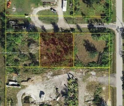 An aerial view shows a rectangular plot of land outlined in yellow among surrounding lots — 29279 HAZELWOOD DRIVE, PUNTA GORDA, FL