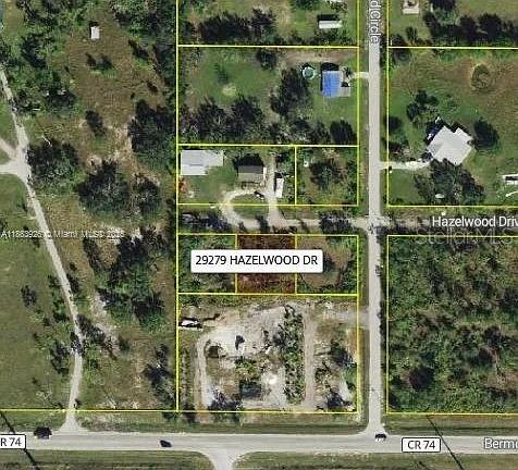 This is an aerial map showing a vacant lot highlighted among surrounding residential properties — 29279 HAZELWOOD DRIVE, PUNTA GORDA, FL