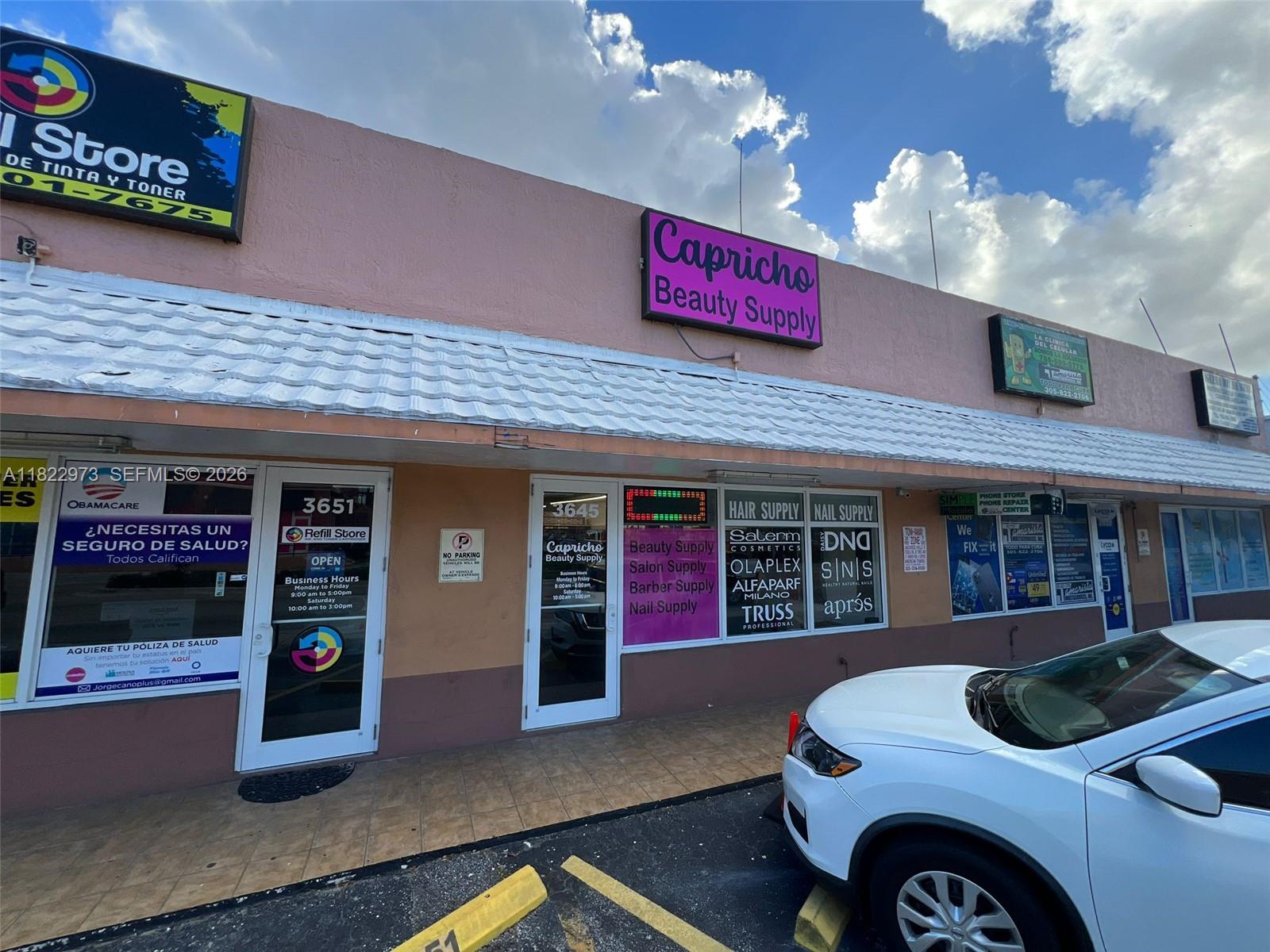 The exterior of a commercial strip mall features storefronts for a beauty supply and refill store — 3645 W 16th Ave,, Hialeah FL 33012, HIALEAH, FL