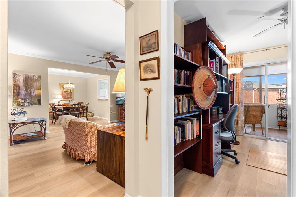 A view through a doorway into a living area, dining room, and a home office — 3910 37TH STREET S UNIT 39, ST PETERSBURG, FL
