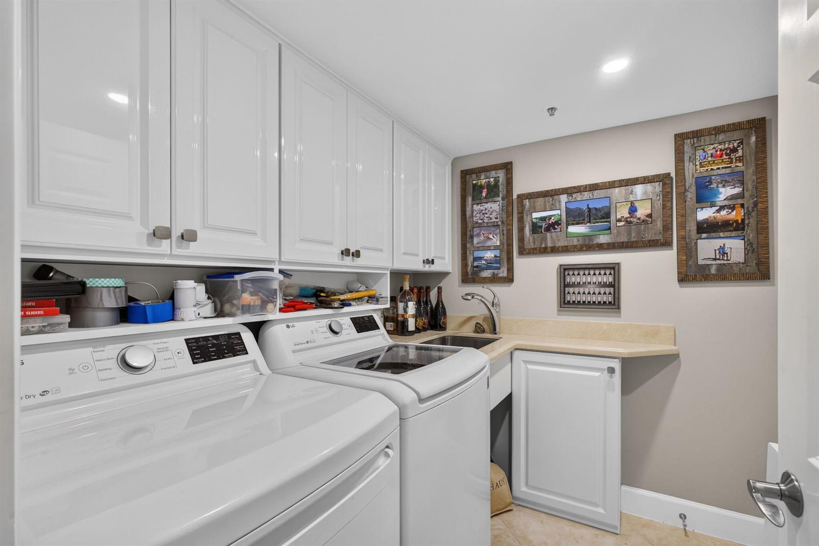 A laundry room with white cabinets, a washer and dryer, and a small utility sink — 5280 N Ocean Drive # 3a, Singer Island FL 33404, SINGER ISLAND, FL