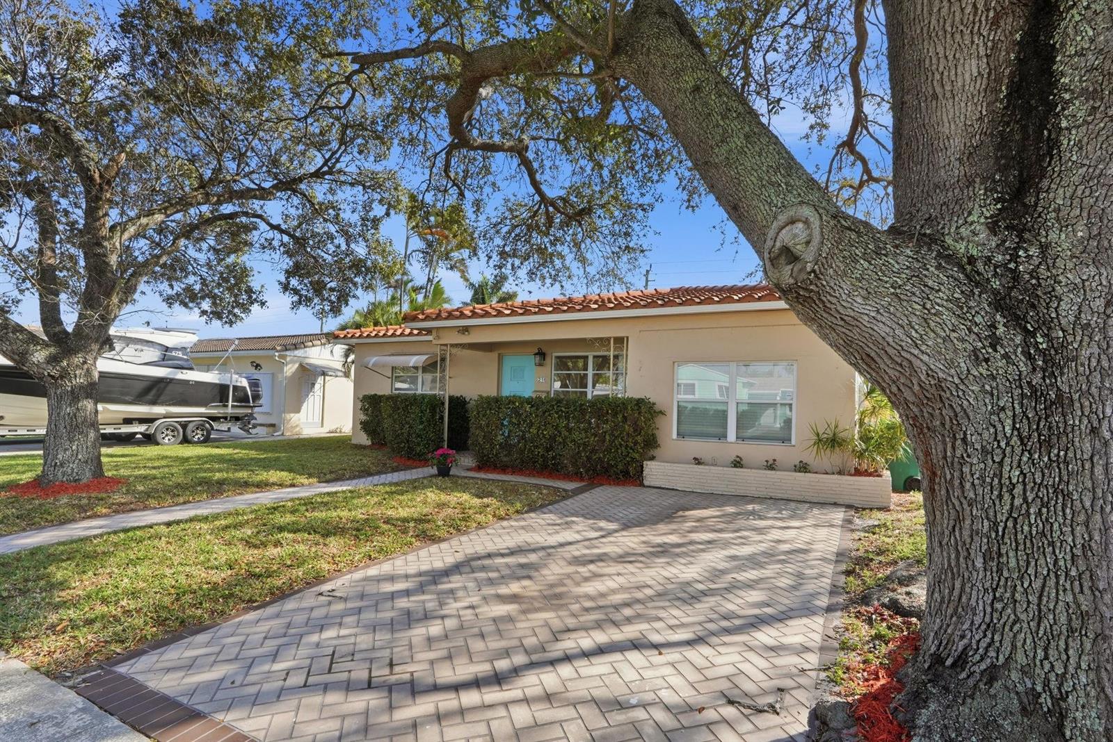 A single-story house with a tiled roof, light-colored exterior, and a paved driveway — 218 SE 3rd Terrace, Dania Beach FL 33004, DANIA BEACH, FL