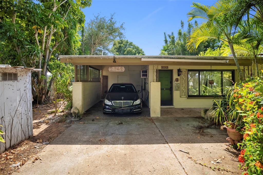 A single-story house features a carport with a parked car and a front entrance — 2742 S EAST AVENUE, SARASOTA, FL