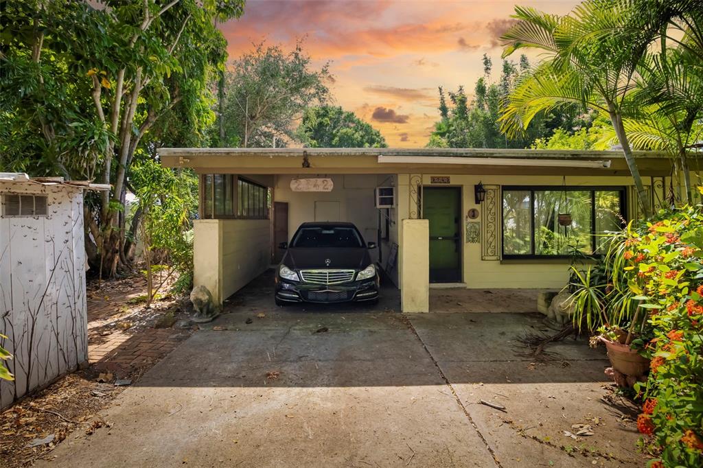 A single-story house features a carport with a parked car and a front entrance — 2742 S EAST AVENUE, SARASOTA, FL