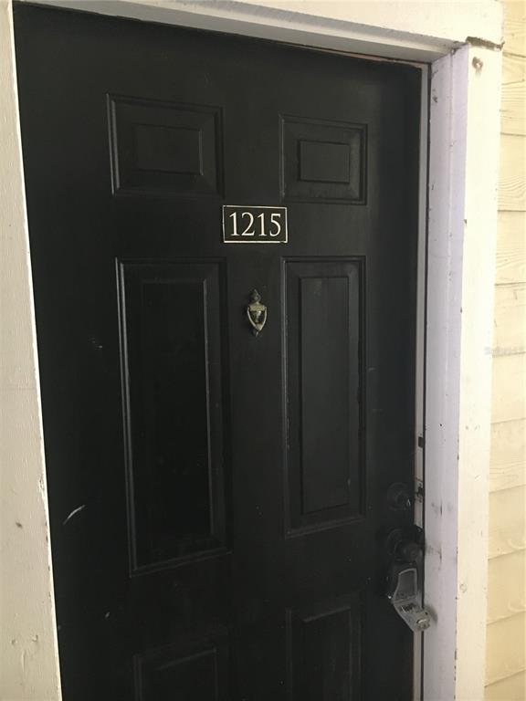 A black front door with a door knocker and the number 1215 mounted above — 2572 ROBERT TRENT JONES DRIVE UNIT 1215, ORLANDO, FL