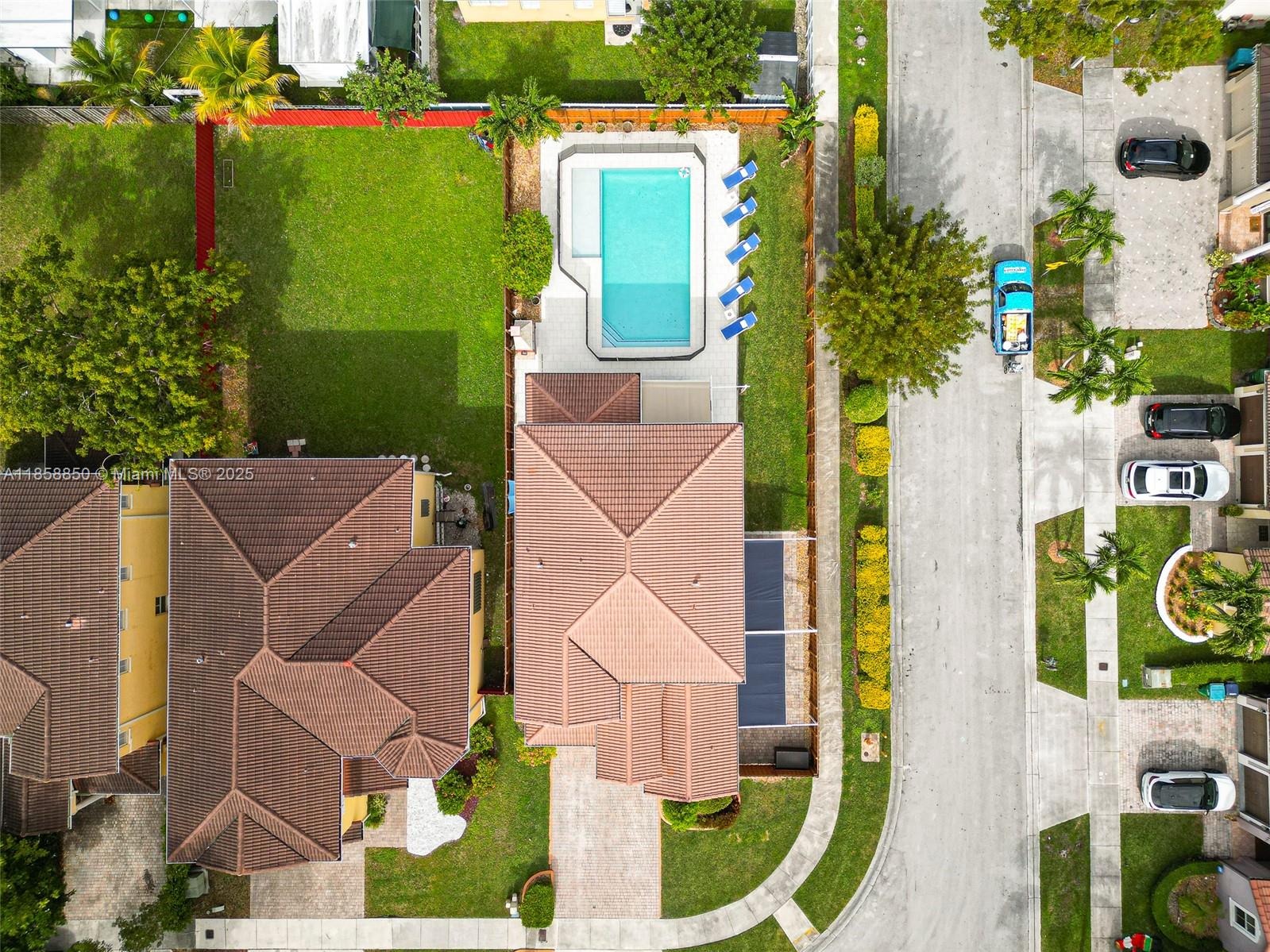 An aerial view shows a house with a tiled roof, a swimming pool, and backyard — 16403 SW 79th Ln # 16403, Miami FL 33193, MIAMI, FL