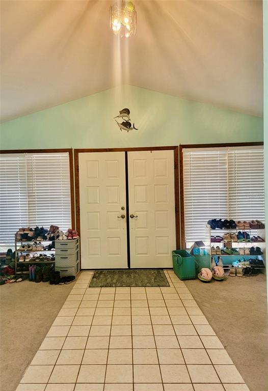 An entryway features a tiled floor, double doors, two shoe racks, and a vaulted ceiling — 585 E FORESTHILL PLACE, HERNANDO, FL