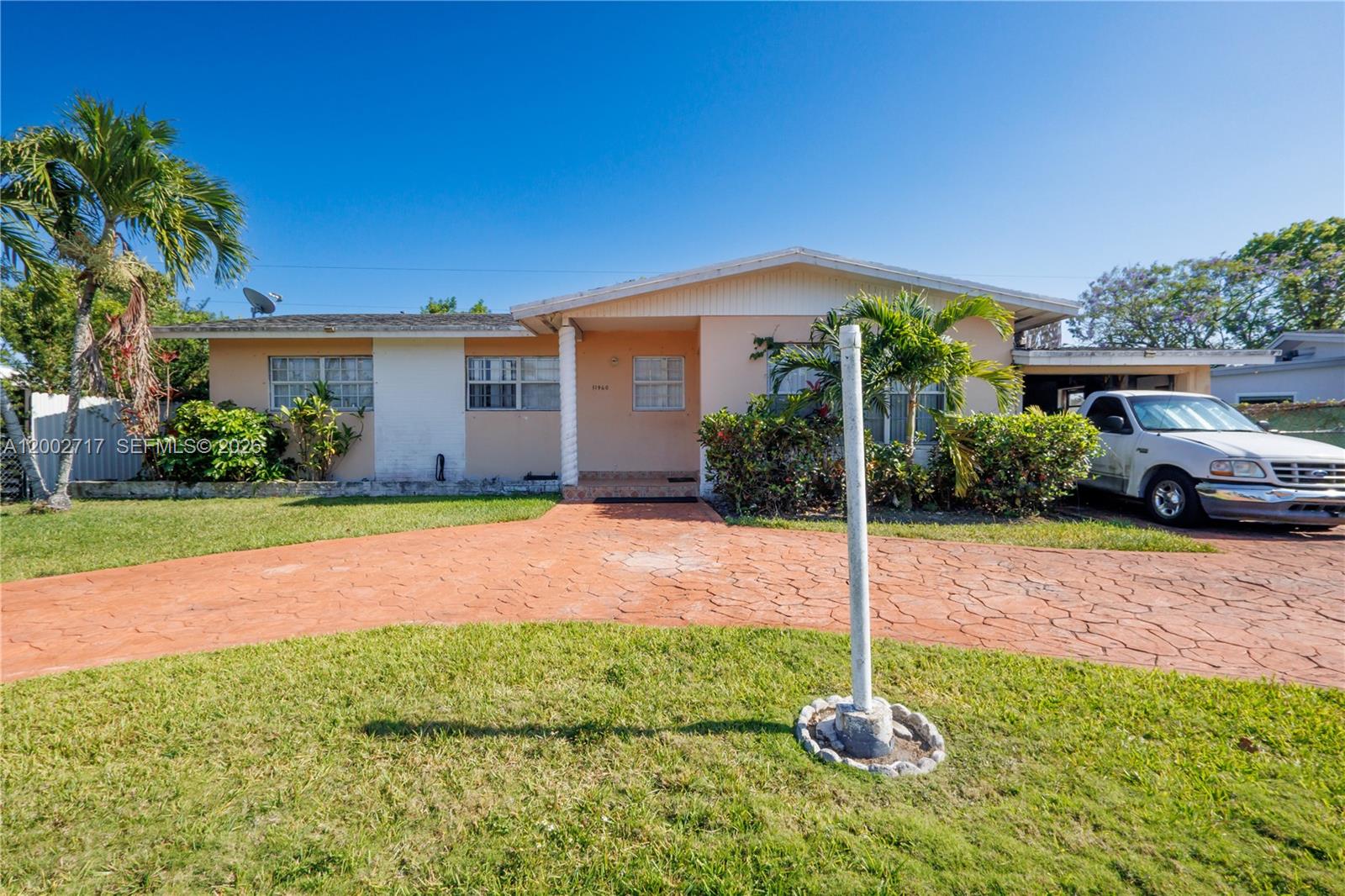 A single-story house with a stamped concrete driveway and a white truck parked outside — 11960 SW 176th St, Miami FL 33177, MIAMI, FL