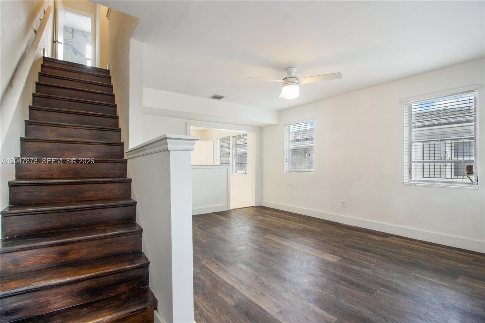 A room with dark wood flooring, a wooden staircase, and a ceiling fan — 2352 SW 26th Ln, Miami FL 33133, MIAMI, FL