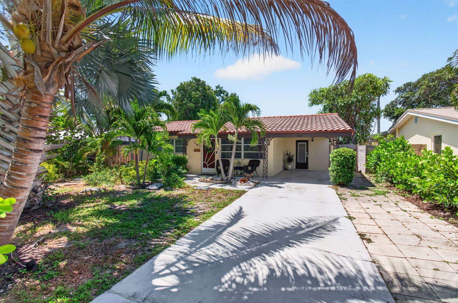 A single-story house with a tiled roof, concrete driveway, and palm trees in the front yard — 183 Harvard Drive, Lake Worth FL 33460, LAKE WORTH, FL