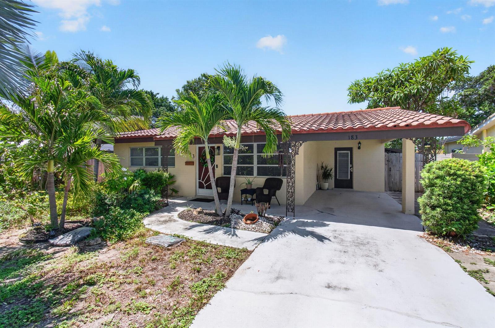 A single-story house with a tiled roof, a carport, and palm trees in the front yard — 183 Harvard Drive, Lake Worth FL 33460, LAKE WORTH, FL