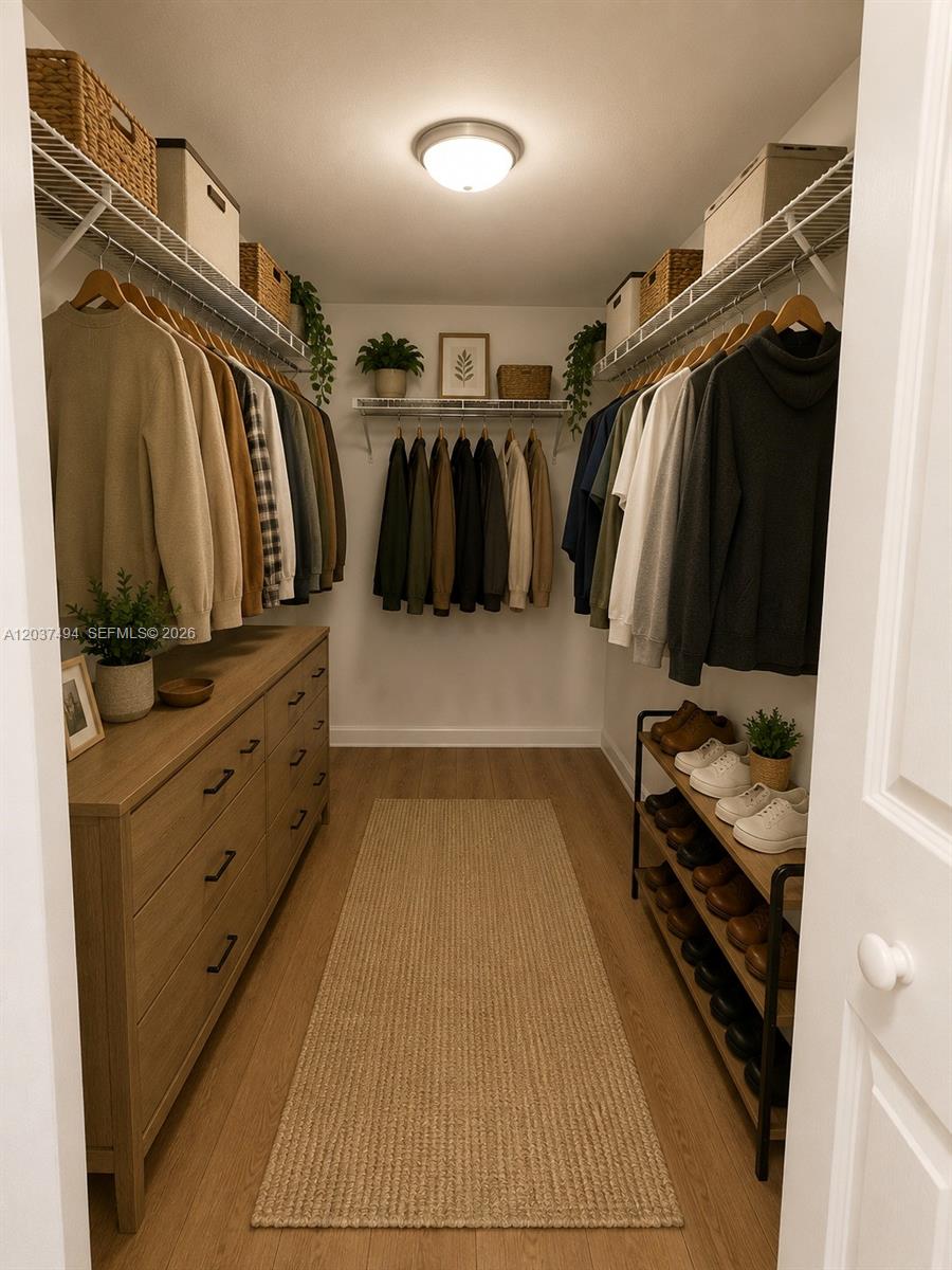 A walk-in closet features hanging clothes, a wooden dresser, a shoe rack, and shelving — 2812 NW 55th Ave # 2A, Lauderhill FL 33313, LAUDERHILL, FL