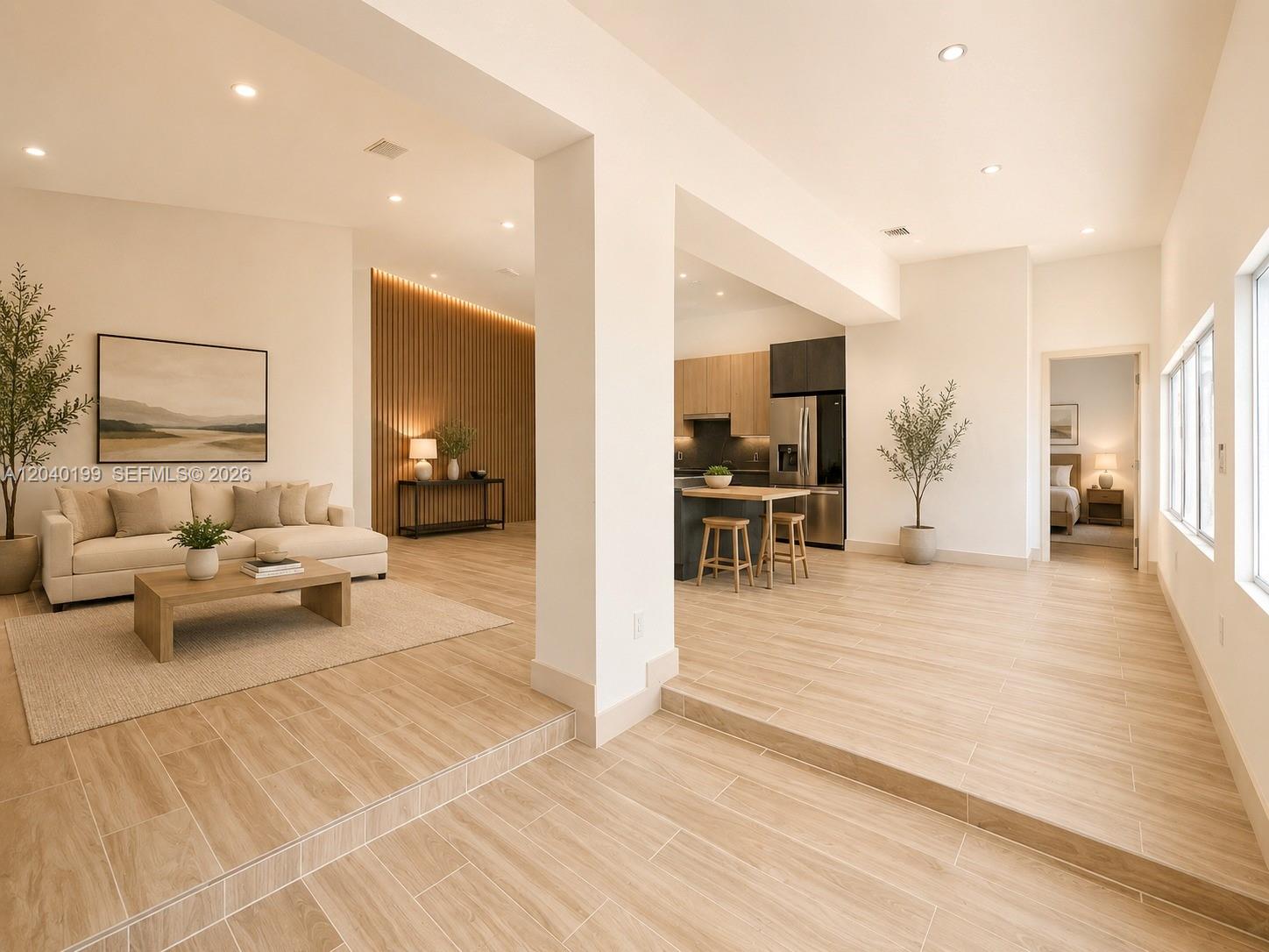 A living room and kitchen area feature light wood-look tile flooring and recessed lighting — 4605 N Miami Ave, Miami FL 33127, MIAMI, FL