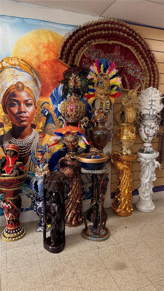 A room displays several ornate, colorful statues and decorative pedestals against a large wall mural — 1580 W 37 St, Hialeah FL 33012, HIALEAH, FL