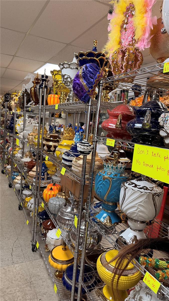 Metal shelving units are filled with various decorative ceramic bowls, jars, and ornate table centerpieces — 1580 W 37 St, Hialeah FL 33012, HIALEAH, FL