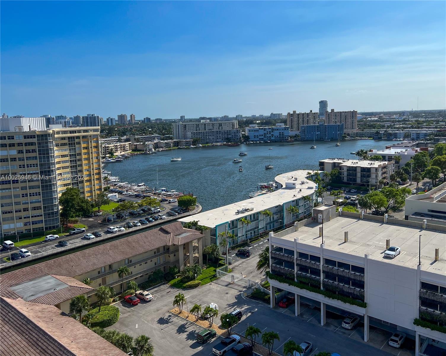 An elevated view shows a waterfront residential area with apartment buildings, a marina, and parked cars — 2602 E HALLANDALE BEACH BLVD # 1605, Hallandale Beach FL 33009, HALLANDALE BEACH, FL