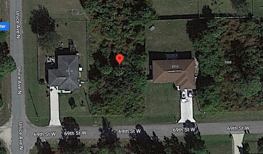 This aerial map shows a vacant, tree-covered lot situated between two existing residential properties — 3512 69TH STREET W, LEHIGH ACRES, FL