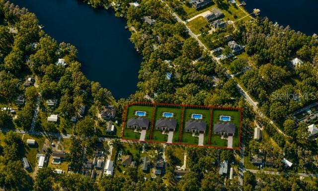 An aerial view shows four identical houses with swimming pools outlined in red — 1444 CHESAPEAKE DRIVE, ODESSA, FL