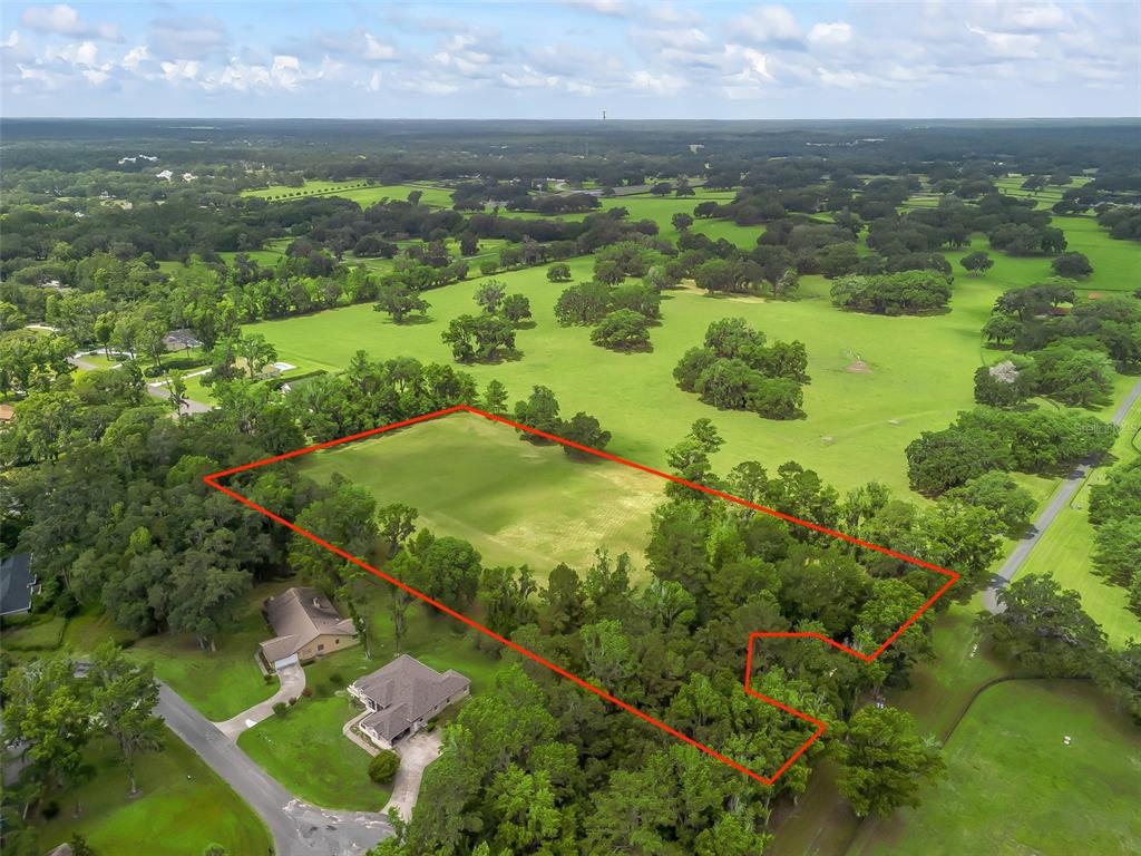 An aerial view shows a rectangular plot of land outlined in red amidst grassy fields — 4698 NW 84TH TERRACE NW, OCALA, FL