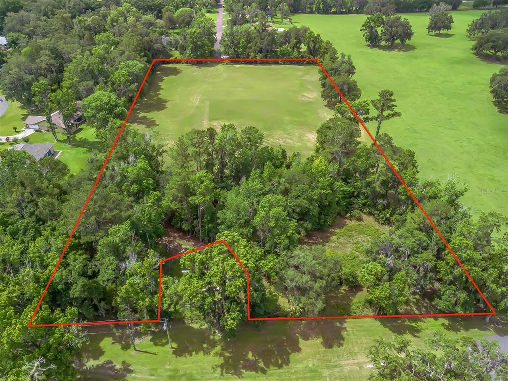 An aerial view shows a large, rectangular plot of land outlined in red — 4698 NW 84TH TERRACE NW, OCALA, FL
