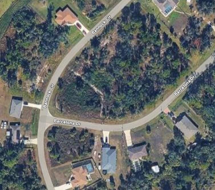 This is an aerial map view of a vacant, wooded corner lot at a street intersection — Lot 2 BANNOCK CIRCLE, NORTH PORT, FL