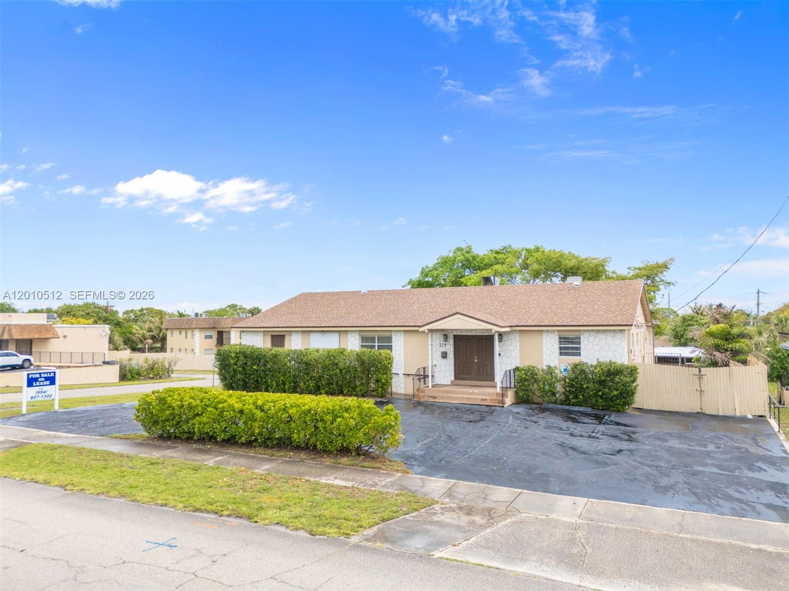A single-story building with a brown roof, tan walls, and a paved parking lot — 359 10th St, Lake Park FL 33403, LAKE PARK, FL