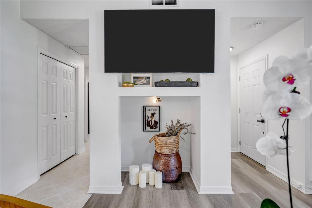A bright living room features a white sofa, wooden accent tables, and a ceiling fan — 5811 MABEL STREET, TAMPA, FL