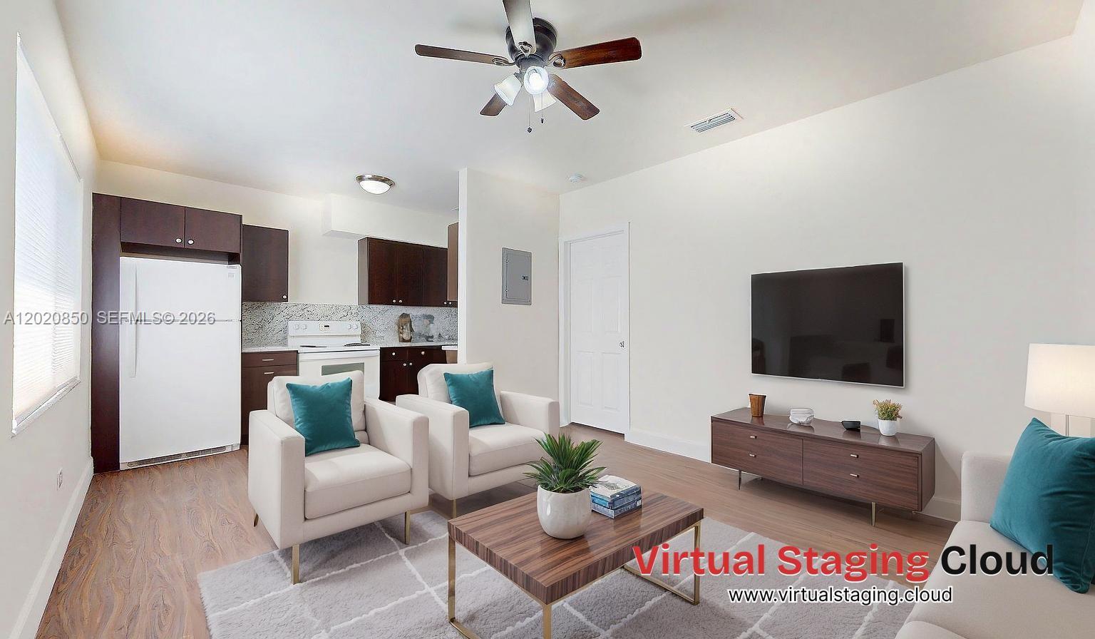 An open-concept kitchen with dark cabinets and wood-look flooring connects to a living area — 74 W 15th St # 2, Hialeah FL 33010, HIALEAH, FL