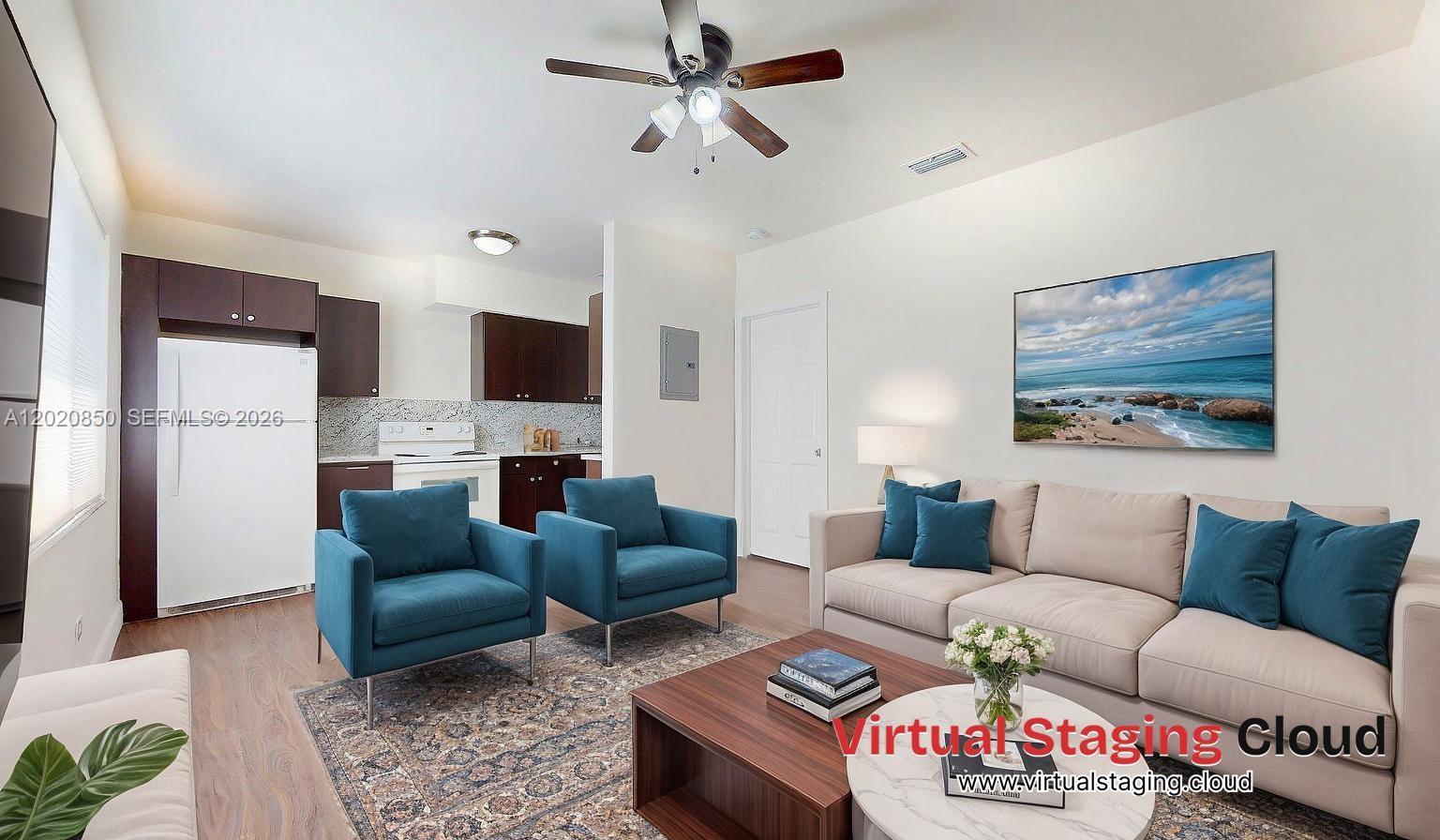 A living room with a television, coffee table, and two chairs faces an open kitchen — 74 W 15th St # 2, Hialeah FL 33010, HIALEAH, FL