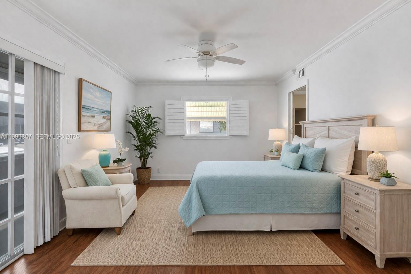 A bedroom features a light blue quilt, a beige armchair, and a ceiling fan — 294 Brittany G # 294, Delray Beach FL 33446, DELRAY BEACH, FL