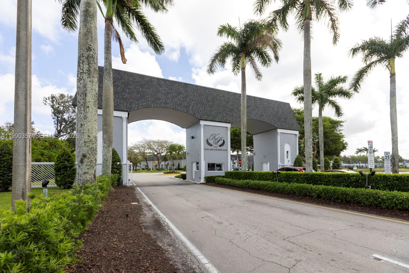 A large stone archway serves as the entrance to a golf and country club — 294 Brittany G # 294, Delray Beach FL 33446, DELRAY BEACH, FL