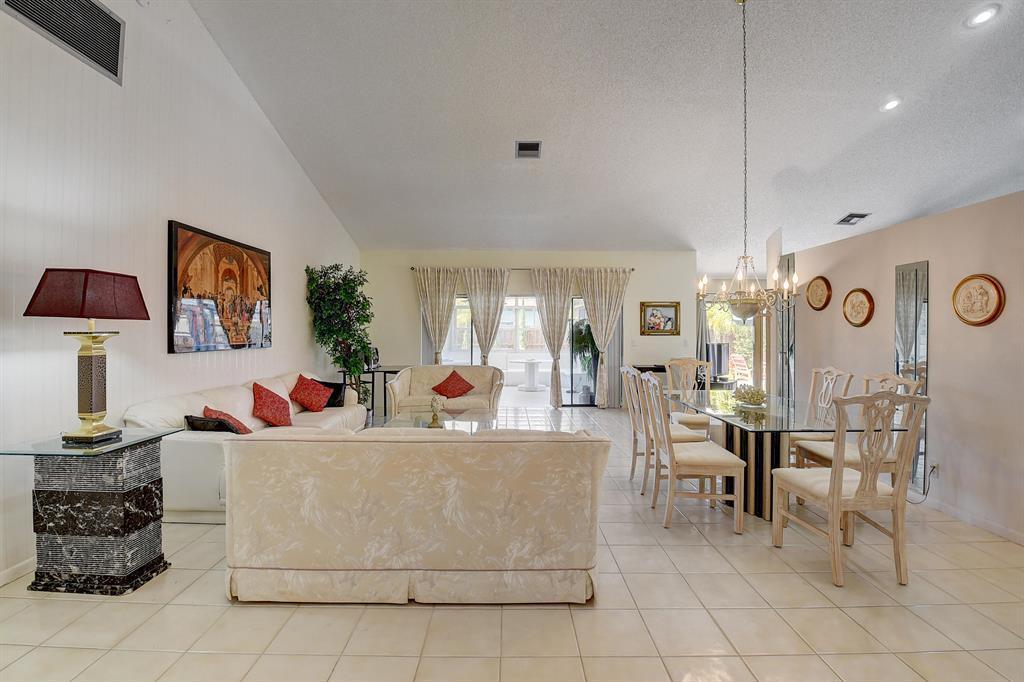 A living and dining room with tile floors, a glass table, and white sofas — 9565 El Clair Ranch Road, Boynton Beach FL 33437, BOYNTON BEACH, FL