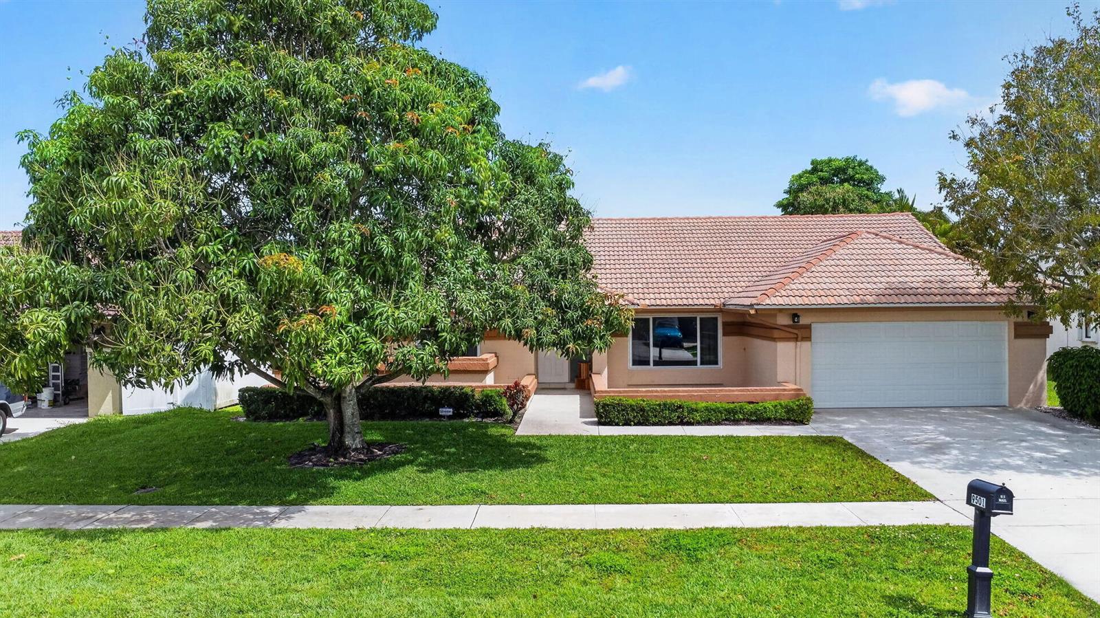 A single-story house with a tiled roof, a large tree, and a two-car garage — 9501 Majestic Way, Boynton Beach FL 33437, BOYNTON BEACH, FL