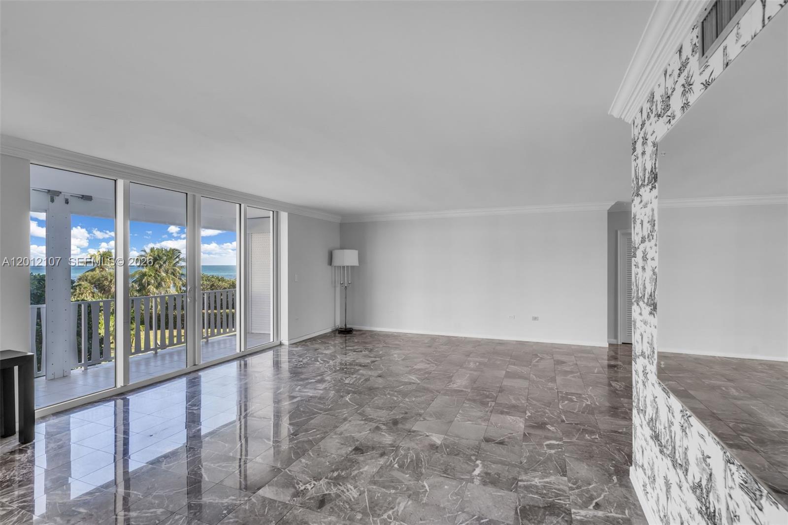 A spacious room with polished marble floors, white walls, and a balcony overlooking the ocean — 200 Ocean Lane Dr # 407, Key Biscayne FL 33149, KEY BISCAYNE, FL