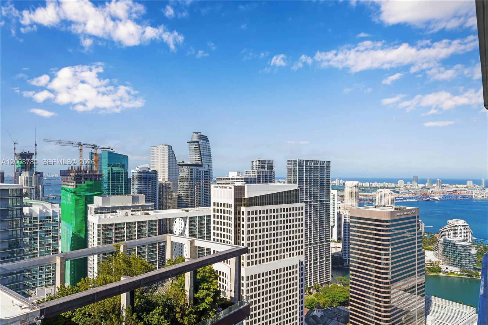 A high-angle view of the Miami skyline featuring various skyscrapers, construction cranes, and the bay — 801 S Miami Ave # 5206, Miami FL 33130, MIAMI, FL